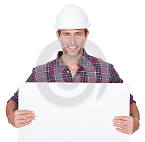 Man Wearing Hard Hat Holding Placard