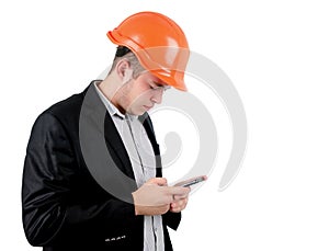Man wearing a hardhat checking his mobile
