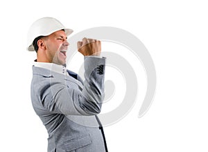 Man wearing a hardhat cheering in jubilation