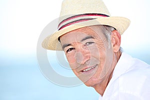 Man wearing hat by coast