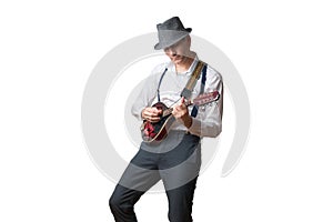 Man wearing hat is concentrated playing the mandolin