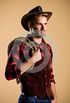 Man wearing hat hold rope. Ranch occupations. Lasso tool of American cowboy. Lasso is used in rodeos part competitive