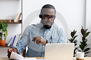 Man wearing headphones learn foreign language indoors