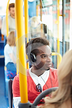 Man Wearing Headphones Listening To Music On Bus Journey