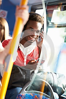 Man Wearing Headphones Listening To Music On Bus Journey