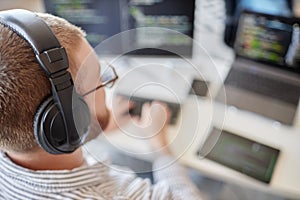 Man Wearing Headphones While Working on Computer Code