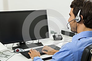 Man wearing headset giving online chat and support