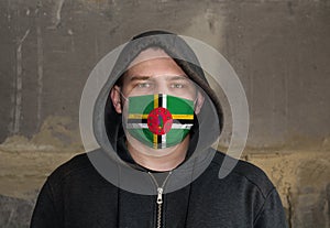 Man Wearing a hood and a Dominicana flag Mask to Protect him virus
