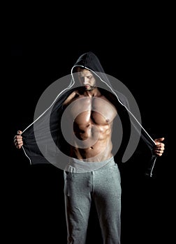 Man wearing hoodie posing in gym