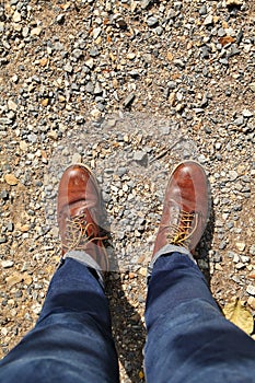 Man wearing leather boots standing on country road