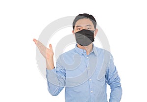 A man wearing a mask makes an explanatory gesture in front of a white background