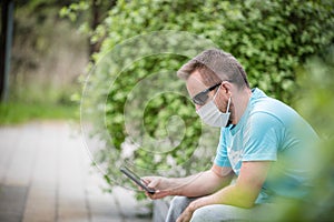 Man wearing a mask with smartphone