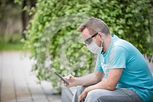 Man wearing a mask with smartphone