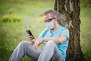 Man wearing a mask with smartphone