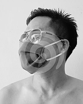 Man wearing mask and sunglasses against white background