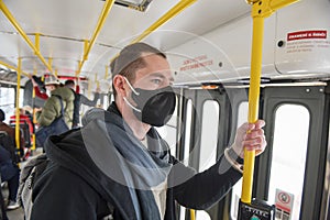 A man wearing a medical mask on a Prague tram during the coronavirus pandemic.