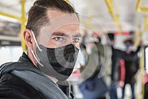 A man wearing a medical mask on a Prague tram during the coronavirus pandemic.