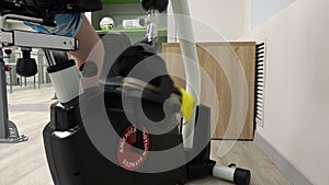 A man wearing a modern robotic exoskeleton on his feet is working out in the gym. Physiotherapy rehabilitation, which