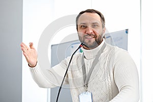Man is wearing pres card or blank badge, speaker photo