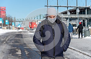 Man wearing protection mask walking in Old Montreal