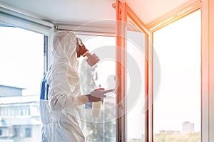 Man wearing protective biological suit and gas-mask due to mers coronavirus global pandemic warning and danger. Medic sphysician