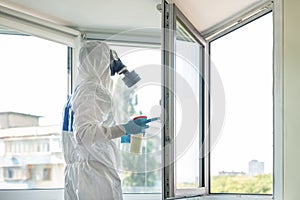 Man wearing protective biological suit and gas-mask due to mers coronavirus global pandemic warning and danger. Medic