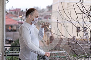 A man wearing a protective mask against the spread of coronavirus disease and talking on a cell phone.