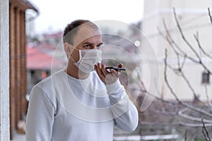 A man wearing a protective mask against the spread of coronavirus disease and talking on a cell phone.