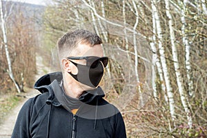 Man wearing protective mask outdoors to prevent coronavirus, covid-19, germs, toxic fumes and dust
