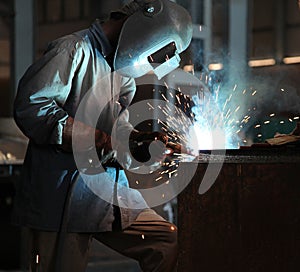 Man welding sheet matal using arc welding photo