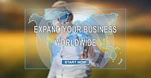 Man wearing a reality virtual headset touching a worldwide business development concept on a touch screen