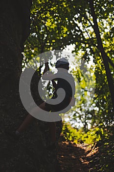 Man wearing a safety helmet while climbing rocks