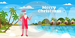 Man wearing santa claus hat using smartphone on tropical beach new year christmas vacation holiday concept seascape