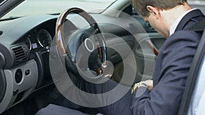 Man wearing seatbelt in car, safety concept, compliance with traffic rules