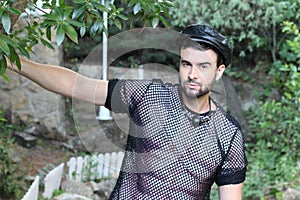 Man wearing see through mesh shirt and butterfly wings