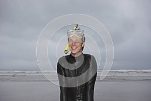 Man Wearing Snorkel And Mask Looking Away On Beach