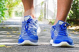 Man wearing sport shoes walking in the park