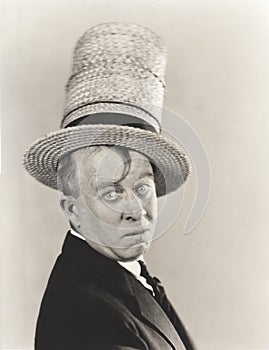 Man wearing stovepipe straw hat photo