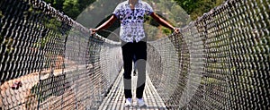 Man wearing stylish dress standing on a foot over bridge