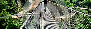 Man wearing stylish dress standing on a foot over bridge