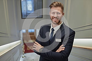 Man Wearing Suit And Looking at Camera in Luxury Hotel Lobby