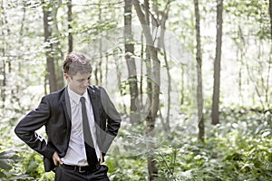 Man wearing suit in woods