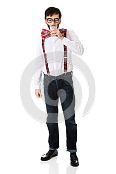 Man wearing suspenders drinking milk.