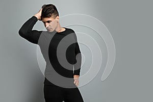 Man wearing thermal underwear on background. Space for text