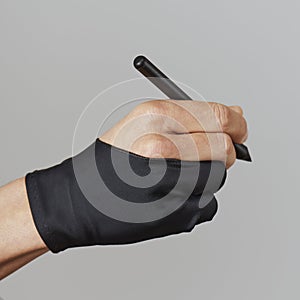 Man wearing a two finger glove using a graphic pen