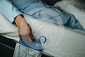 man wearing a urine drainage bag in bed