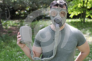 Man wearing vintage gas mask in natural setting