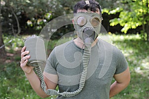 Man wearing vintage gas mask in natural setting