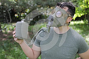 Man wearing vintage gas mask in natural setting