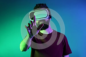 Man wearing virtual reality glasses on dark color background